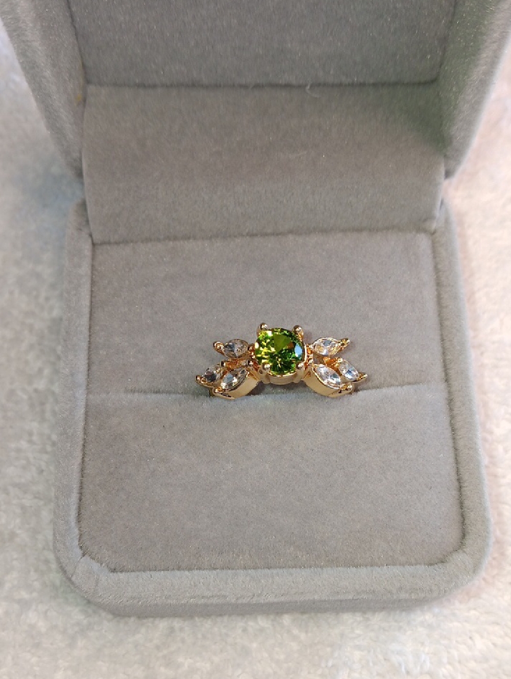 Gold Ring with Green Gemstone and Clear Accent Stones